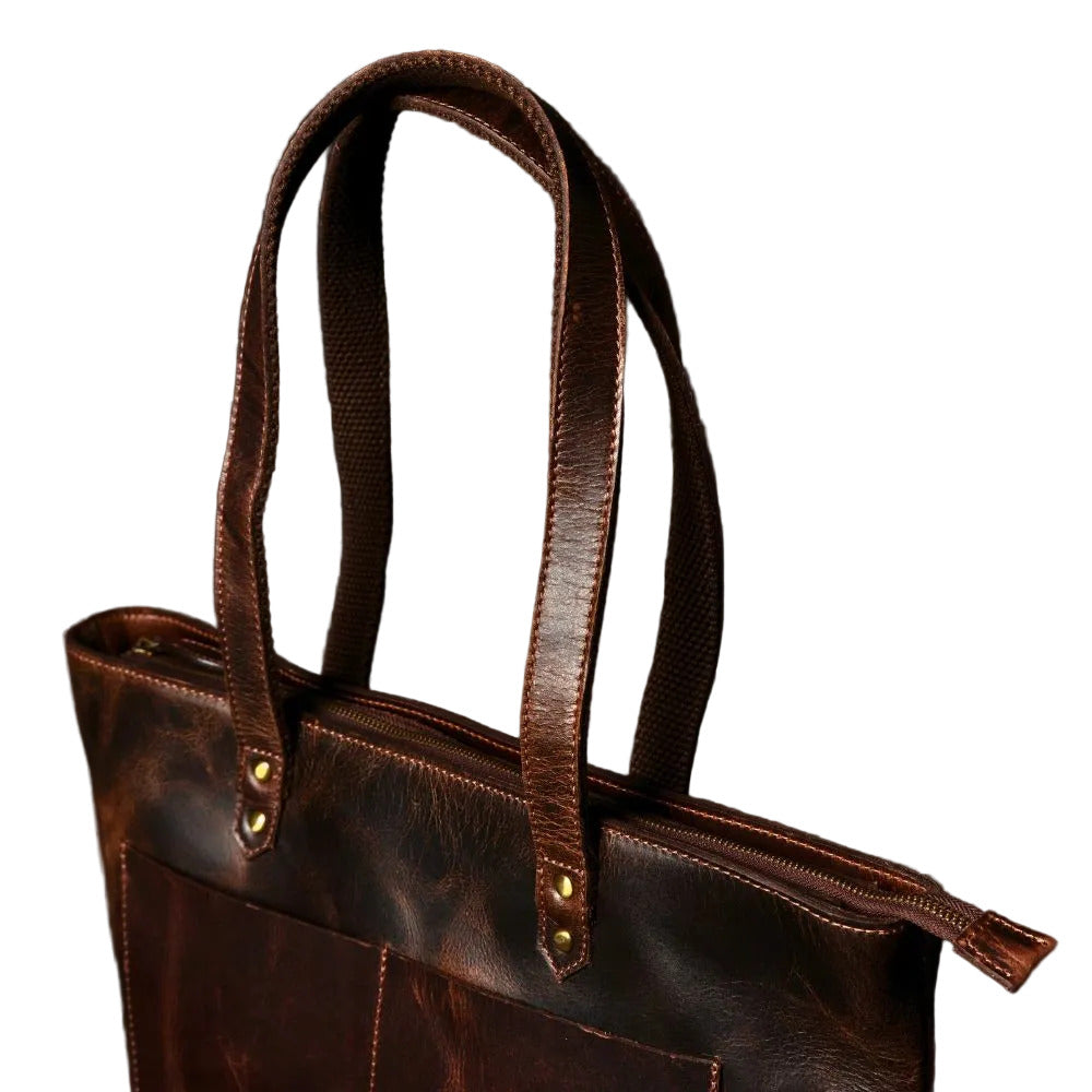 "Close-up of rolled leather handles and hand-stitched top edge on the Classic Brown Leather Tote Bag by NAB Leather"