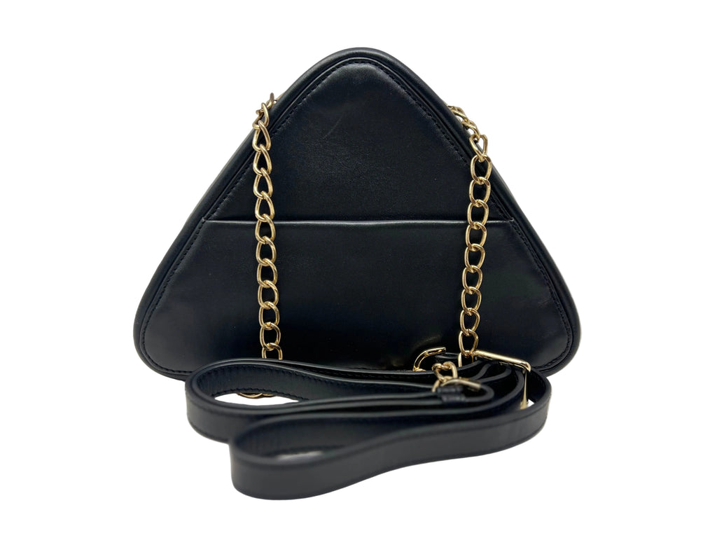 Back view of the Kiana triangular black leather evening bag, highlighting the integrated exterior smartphone slide pocket, a gold chain strap, and a coiled black leather shoulder strap in front.