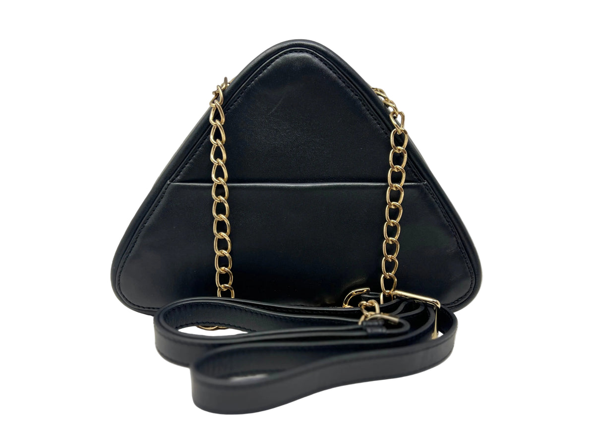 Back view of the Kiana triangular black leather evening bag, highlighting the integrated exterior smartphone slide pocket, a gold chain strap, and a coiled black leather shoulder strap in front.