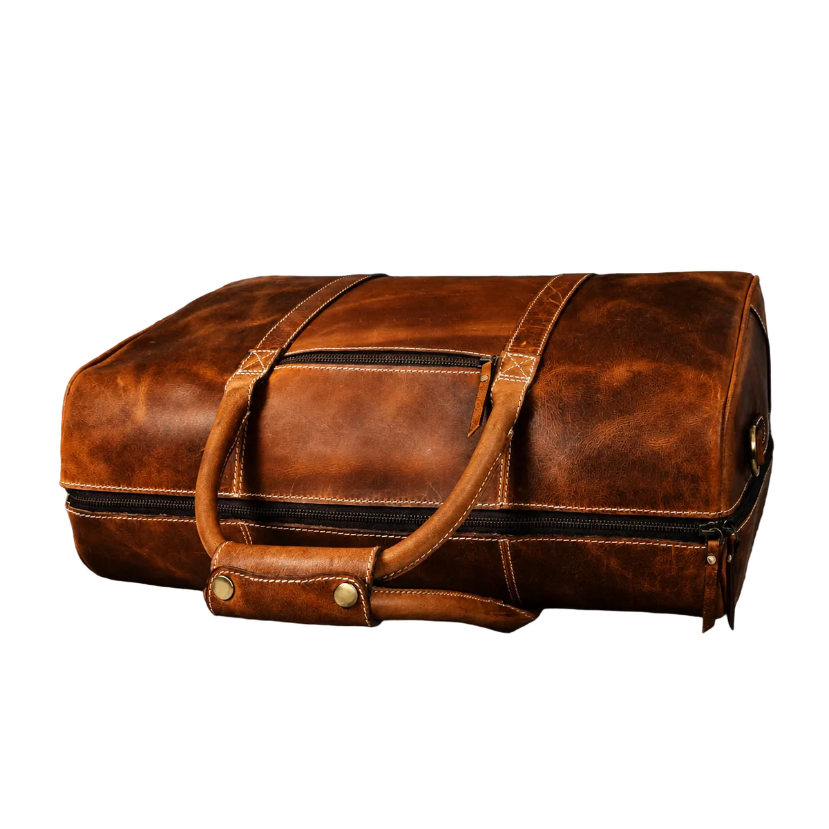 "Low-angle side view of The Wayfarer Bag showing full length and structured depth — cognac full-grain leather duffle handcrafted in Canada by NAB Leather"