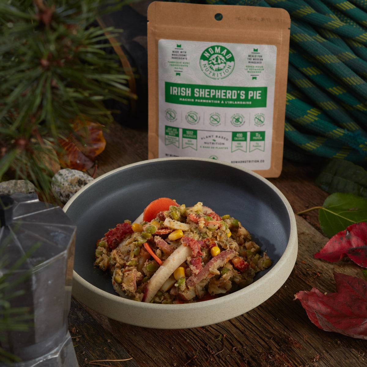 Bowl of food with a package labeled 'Irish Shepherd's Pie' on a natural background