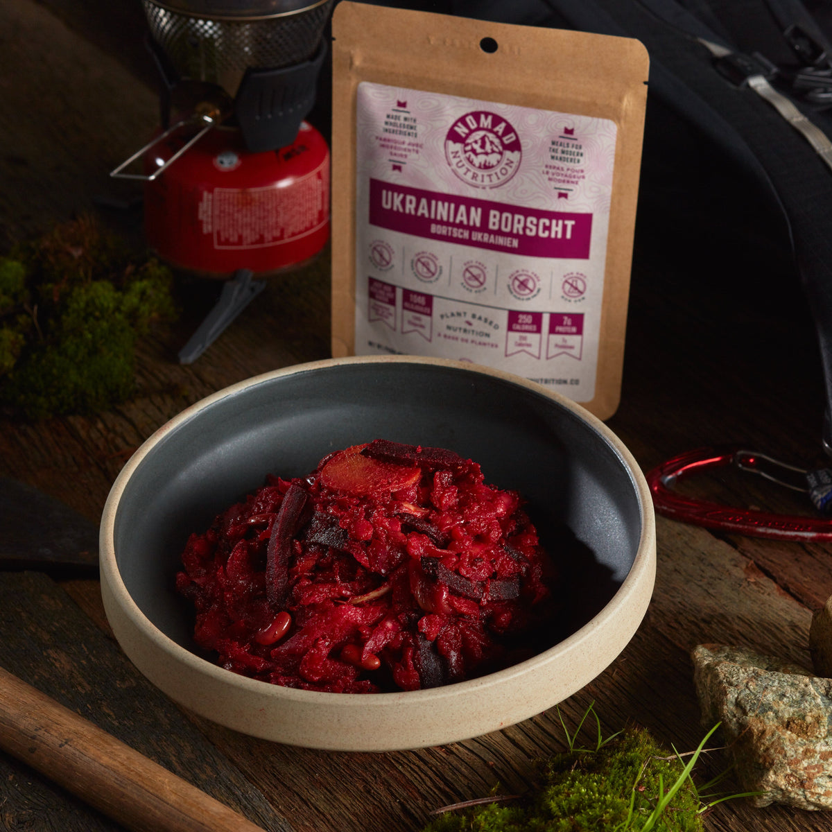 Ukrainian Borscht in a bowl with a package labeled 'Ukrainian Borscht' on a rustic background.